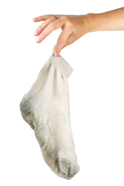 hand-holding-dirty-white-sock-picture-id97747178